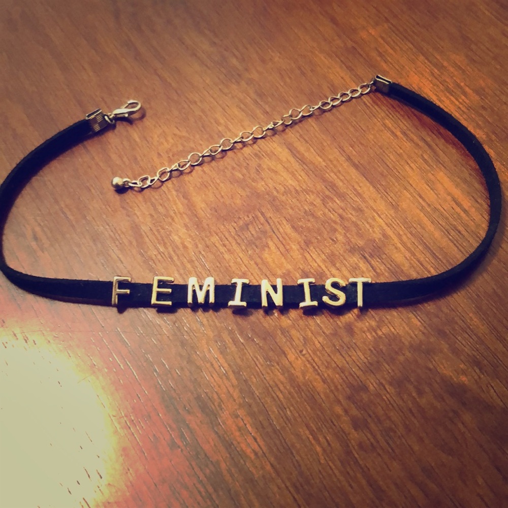 FEMINIST black velvet chocked with gold detail.